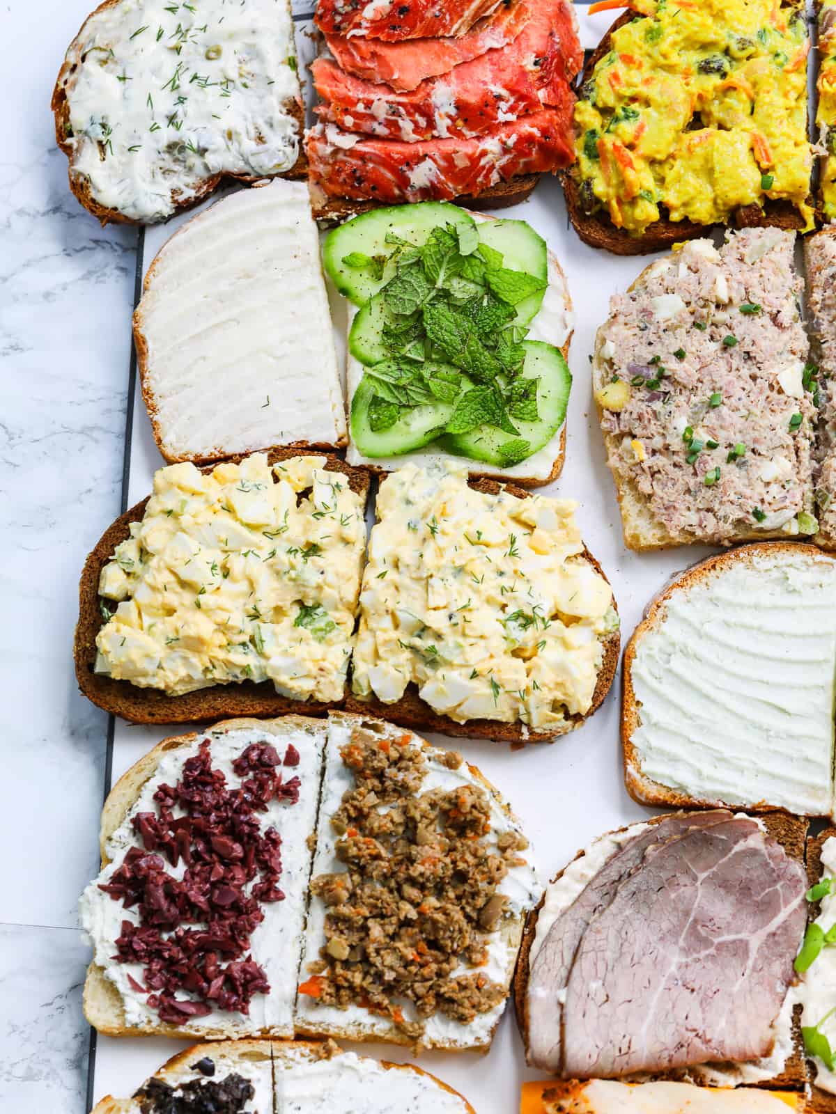 https://www.delicioustable.com/wp-content/uploads/2023/05/Making-sandwiches-including-egg-salad.jpg