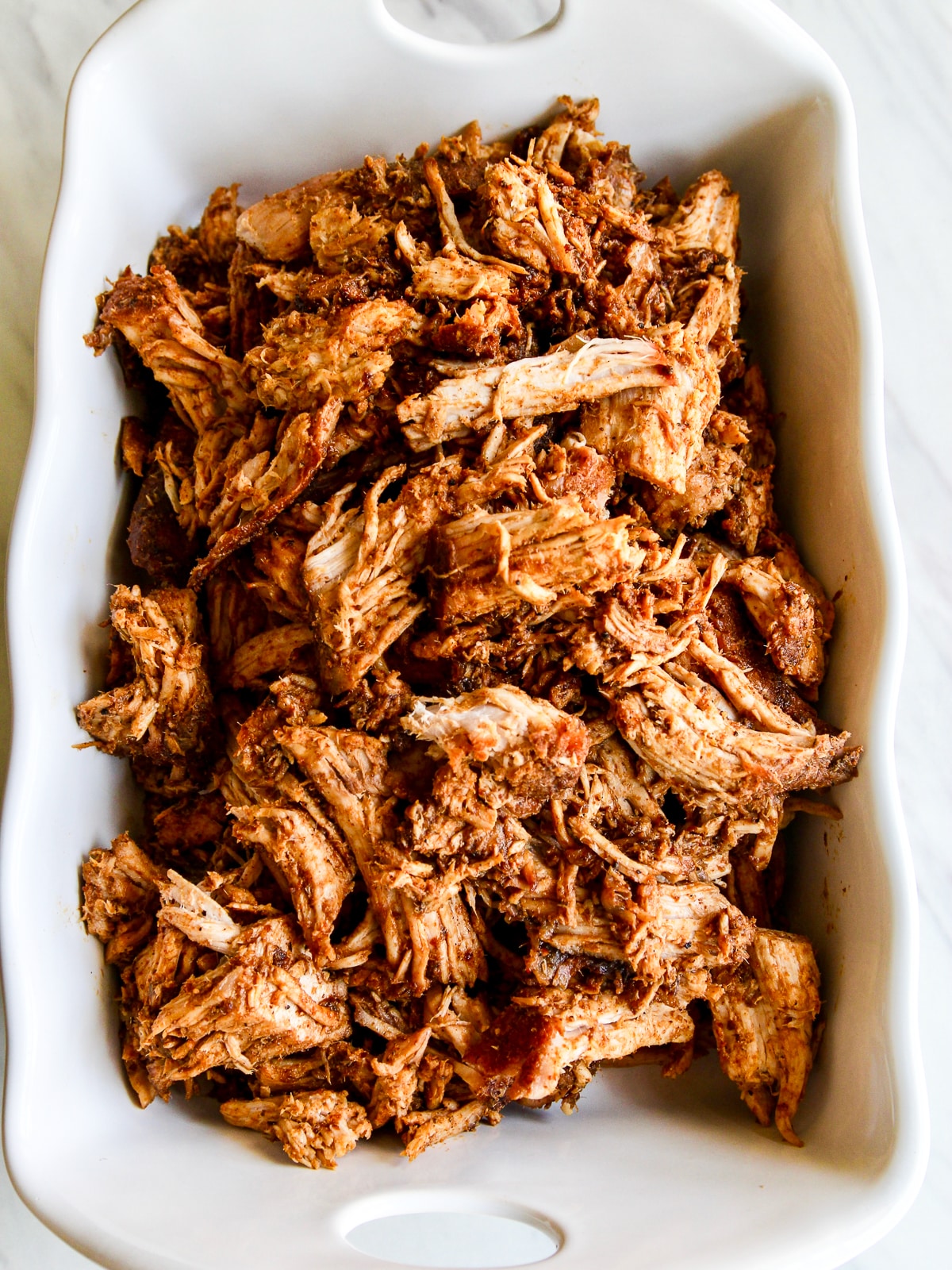 https://www.delicioustable.com/wp-content/uploads/2023/07/Pulled-Pork-Oven-Roasted-Low-Slow-all-the-pork-pulled-in-a-white-dish.jpg